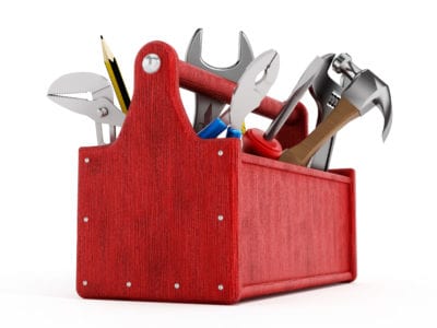 Red toolbox full of hand tools isolated on white background for learning technology tools concept