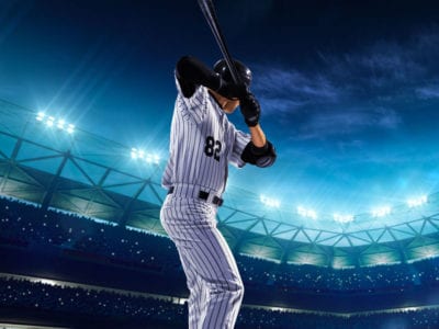 Baseball player at bat in big arena at night for learning business grand slam