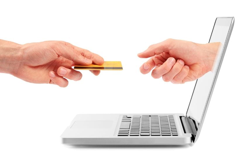 xtransactions vs relationships - photo of two hands exchanging cedit card through laptop screen