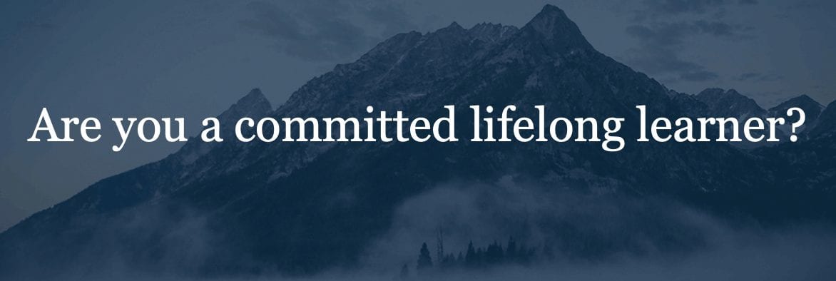 Text "Are you a committed lifelong learner" against transparent backdrop of mountain range