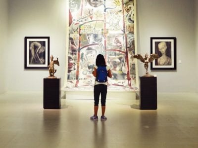 Woman standing in art museum gallery