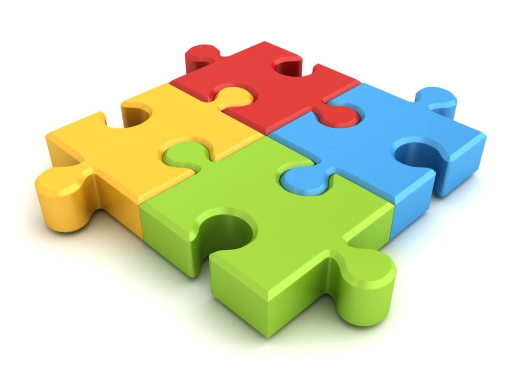 Four colorful puzzle pieces for LMS vs LXP vs LRS vs LCMS concept