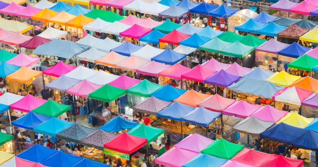 Overhead view of colorful of flea market tent tops in Bangkok Thailand for adult lifelong learning market concept